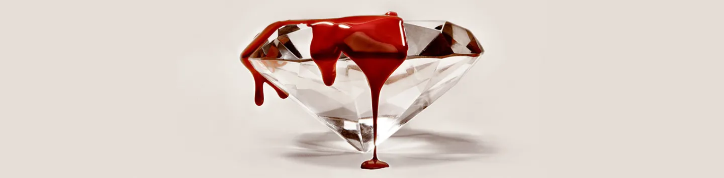 Blood or red paint dripping over diamond