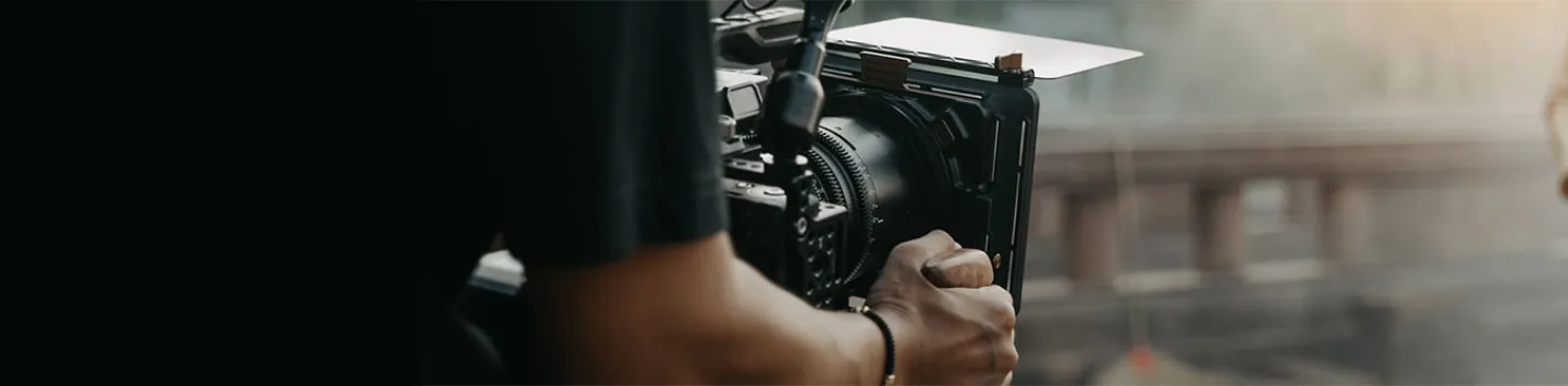 Close up hands holding cinema camera shooting