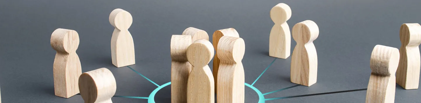 Close-up of wooden figurine against gray background