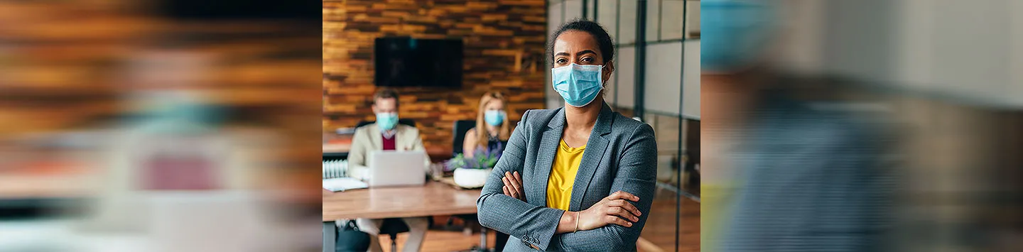 Businesspeople wearing masks in the office for safety during COVID-19 pandemic