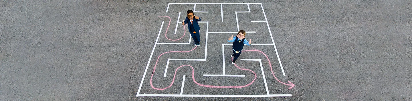 Children playing in a chalk maze