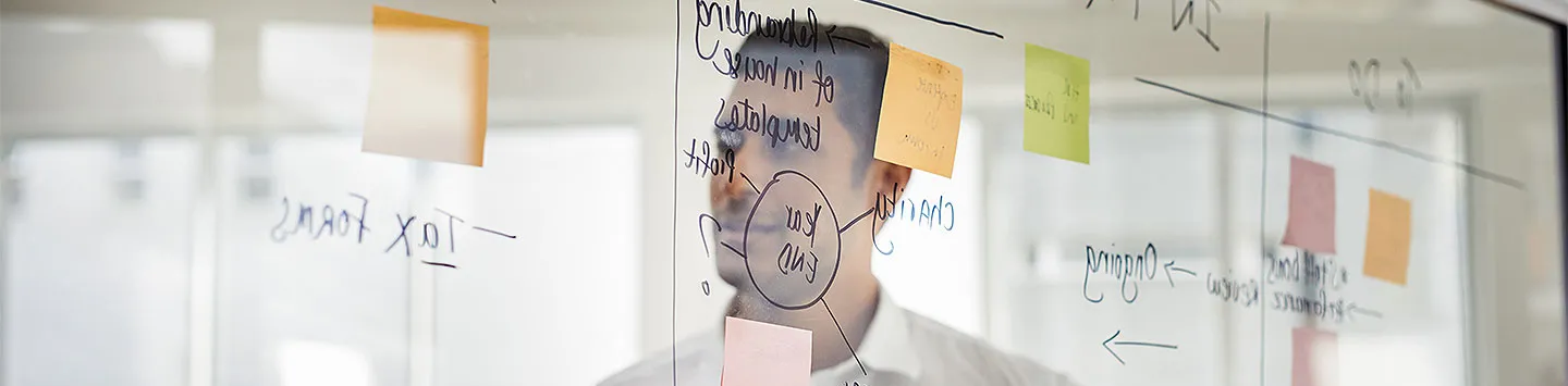 A man reflected in a whiteboard