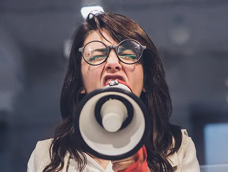 Boss yelling at employees through megaphone