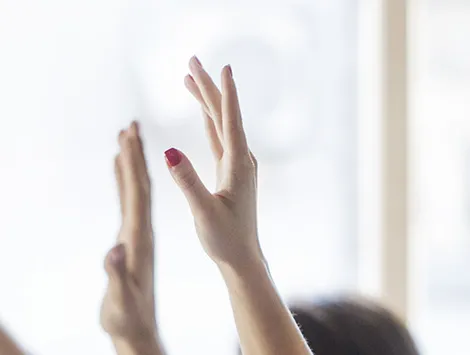 Hands being raised in a classroom setting