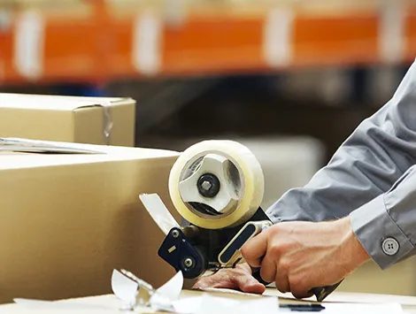 Man taping boxes in warehouse