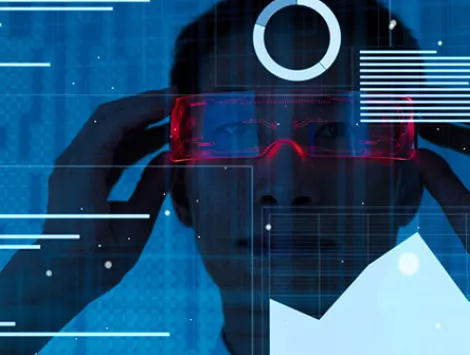 Asian man viewing data using virtual reality glasses