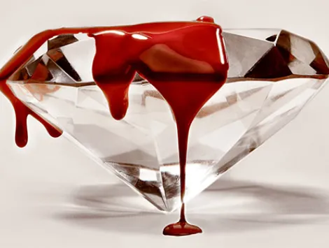 Blood or red paint dripping over diamond