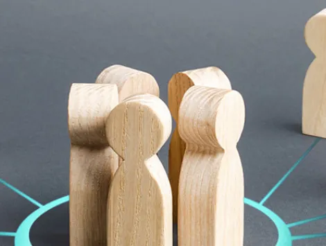 Close-up of wooden figurine against gray background