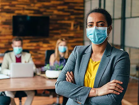 Businesspeople wearing masks in the office for safety during COVID-19 pandemic