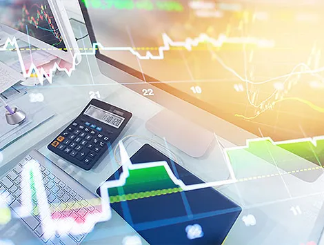 Calculator on a desk with overlays of stocks and data analysis charts