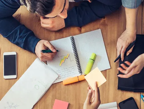 Overhead view on business people around desk