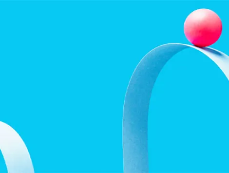 a little red ball on the crest of a wave formed from blue paper, blue background