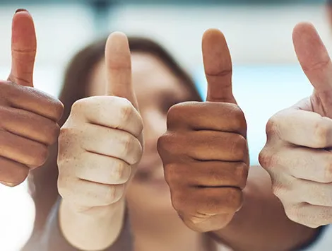 Four people in a row giving the thumbs up sign with their hands