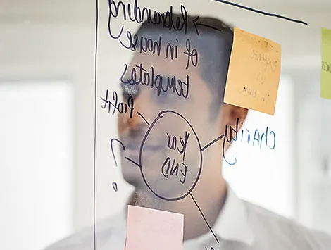 A man reflected in a whiteboard